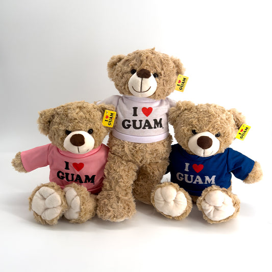 Set of three ‘I ❤️ GUAM’ plush teddy bears wearing pink, white, and blue shirts, perfect as cuddly Guam souvenir gifts for children or collectors.