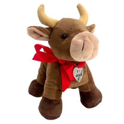 Brown plush carabao toy with a red ribbon and a heart-shaped ‘I ❤️ GUAM’ tag around its neck, symbolizing love for Guam.